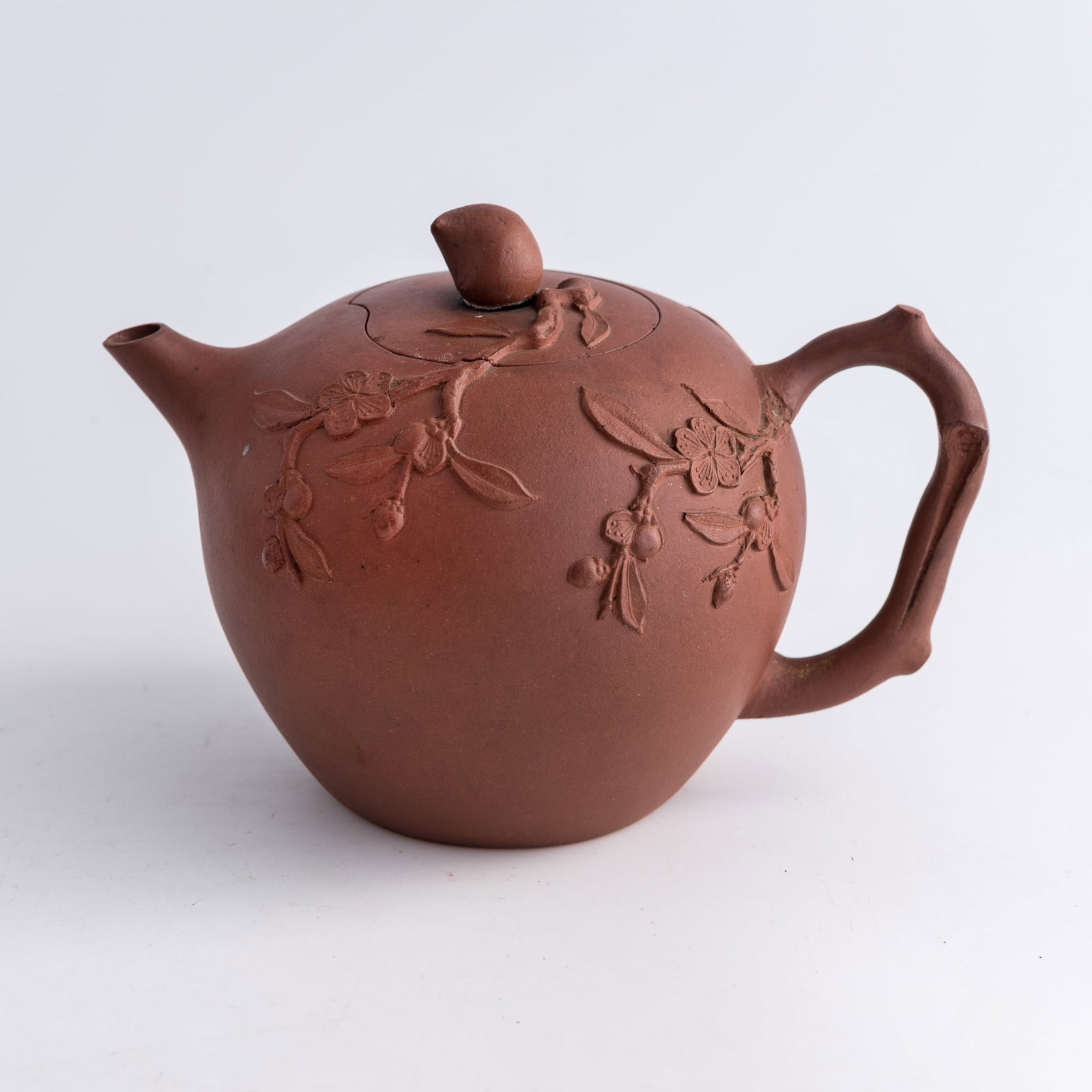 A Chinese Yixing zisha peach-form teapot, Republic period: A Chinese Yixing zisha peach-form teapot Republic period H: 4 1/2, W: 6 3/8, D: 4 3/8 in. (H: 11.4, W: 16.2, D: 11.1 cm.) From Mrs. Cheng of Daly City, California. The items were collected in Hong Kon