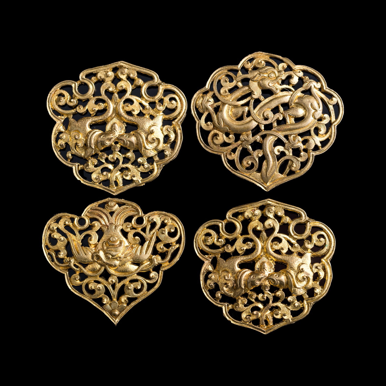 Four Chinese gilt-silver openwork ornaments, Yuan dynasty or earlier: Four Chinese gilt-silver openwork ornaments Yuan dynasty or earlier H: 1 3/8, W: 1 1/2, D: 1/16 in. (H: 3.5, W: 3.8, D: 0.2 cm. (largest)) Weight: 18.04 g (overall) From an estate in Houston, Texas.