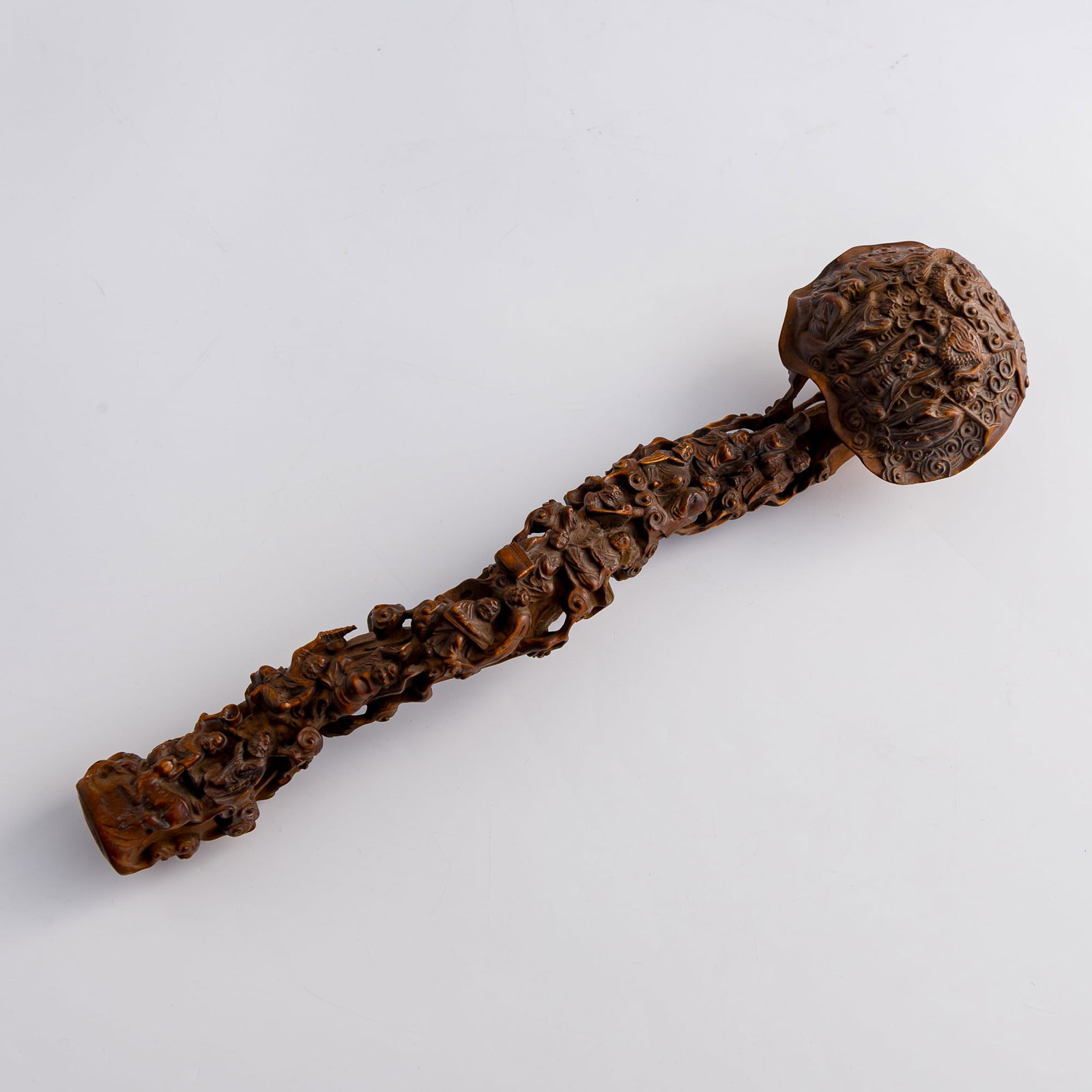 A Chinese carved boxwood 'Eighteen Luohans' ruyi scepter, 19th century: A Chinese carved boxwood 'Eighteen Luohans' ruyi scepter 19th century L: 11 7/8, W: 3, D: 2 1/4 in. (H: 30.2, W: 7.6, D: 5.7 cm.) From an estate in Chicago, Illinois.