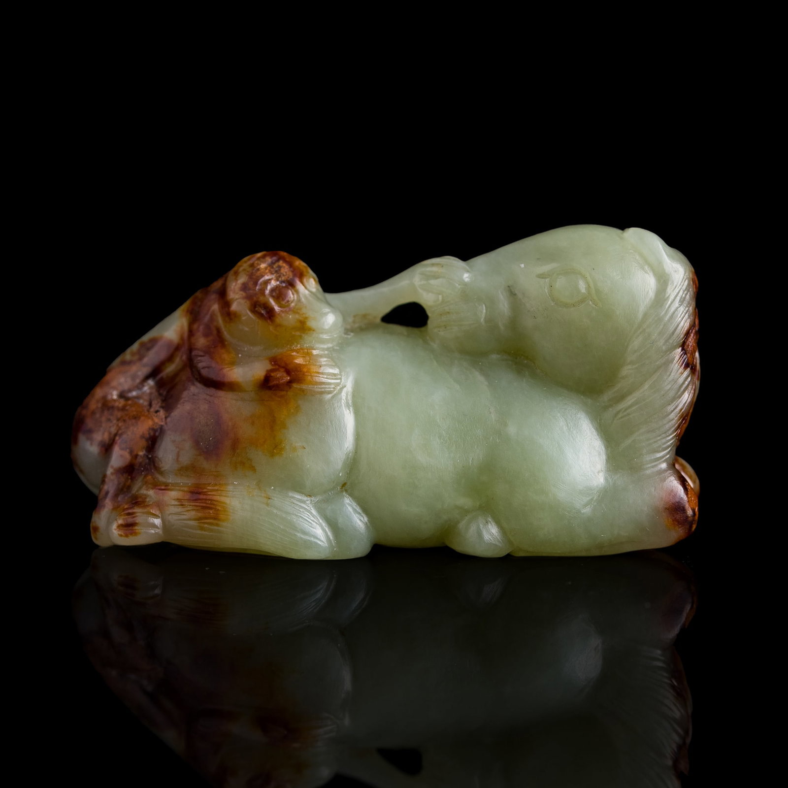 A Chinese russet-skin jade 'monkey on horseback' pendant, 18th century: A Chinese russet-skin jade 'monkey on horseback' pendant 18th century H: 1 1/8, W: 2 1/4, D: 7/8 in. (H: 2.9, W: 5.7, D: 2.2 cm.) From Mr. Yip of Seattle, Washington.