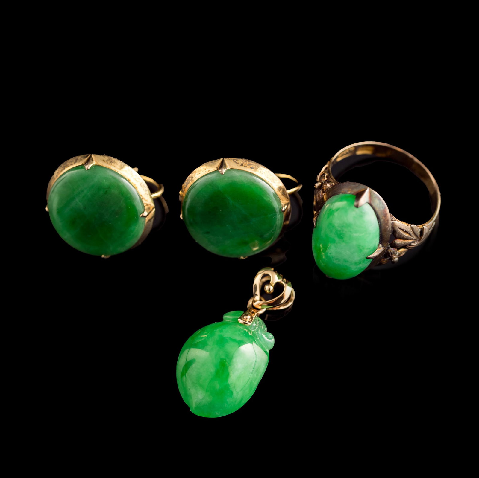 Four Chinese jadeite jewelry items, Qing dynasty/Republic period: Four Chinese jadeite jewelry items Qing dynasty/Republic period Comprising a pair of earrings, a ring and a pendant. Ring with "Yong'an" and "14K" marks to the band interior; pendant with "G 18K" mark
