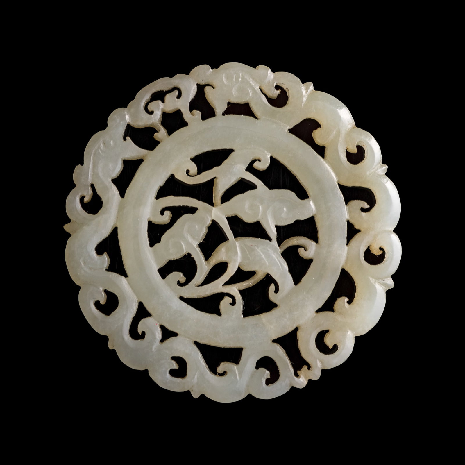 A Chinese white jade openwork 'lingzhi' and 'chilong' pendant, 19th century: A Chinese white jade openwork 'lingzhi' and 'chilong' pendant 19th century Dia: 2 1/8, D: 3/16 in. (Dia: 5.4, D: 0.5 cm.) From Mr. Yip of Seattle, Washington. Clic