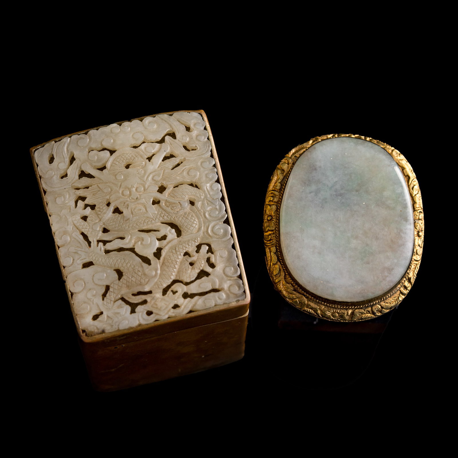 A Chinese white jade-mounted copper box and a jadeite-mounted gilt-copper belt buckle, 18th century: A Chinese white jade-mounted copper box and a jadeite-mounted gilt-copper belt buckle 18th century Box with "CHINA" mark to underside. (2). Box: H: 3 1/8, W: 2 5/8, D: 2 1/4 in. (H: 7.9, W: 6.7, D: 5.