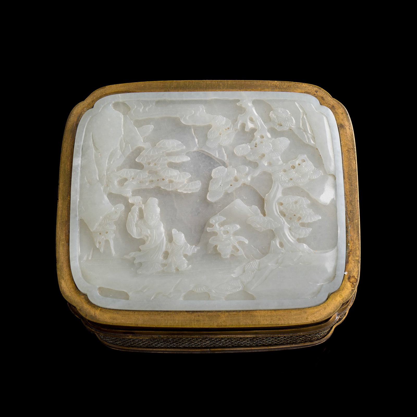 A Chinese carved 'pine tree' and 'scholar' jade plaque- inlaid copper box, mid-Qing dynasty: A Chinese carved 'pine tree' and 'scholar' jade plaque- inlaid copper box mid-Qing dynasty Jade carved with two figures, one holding a lingzhi, walking amongst tall pine trees in a mountainous landsca