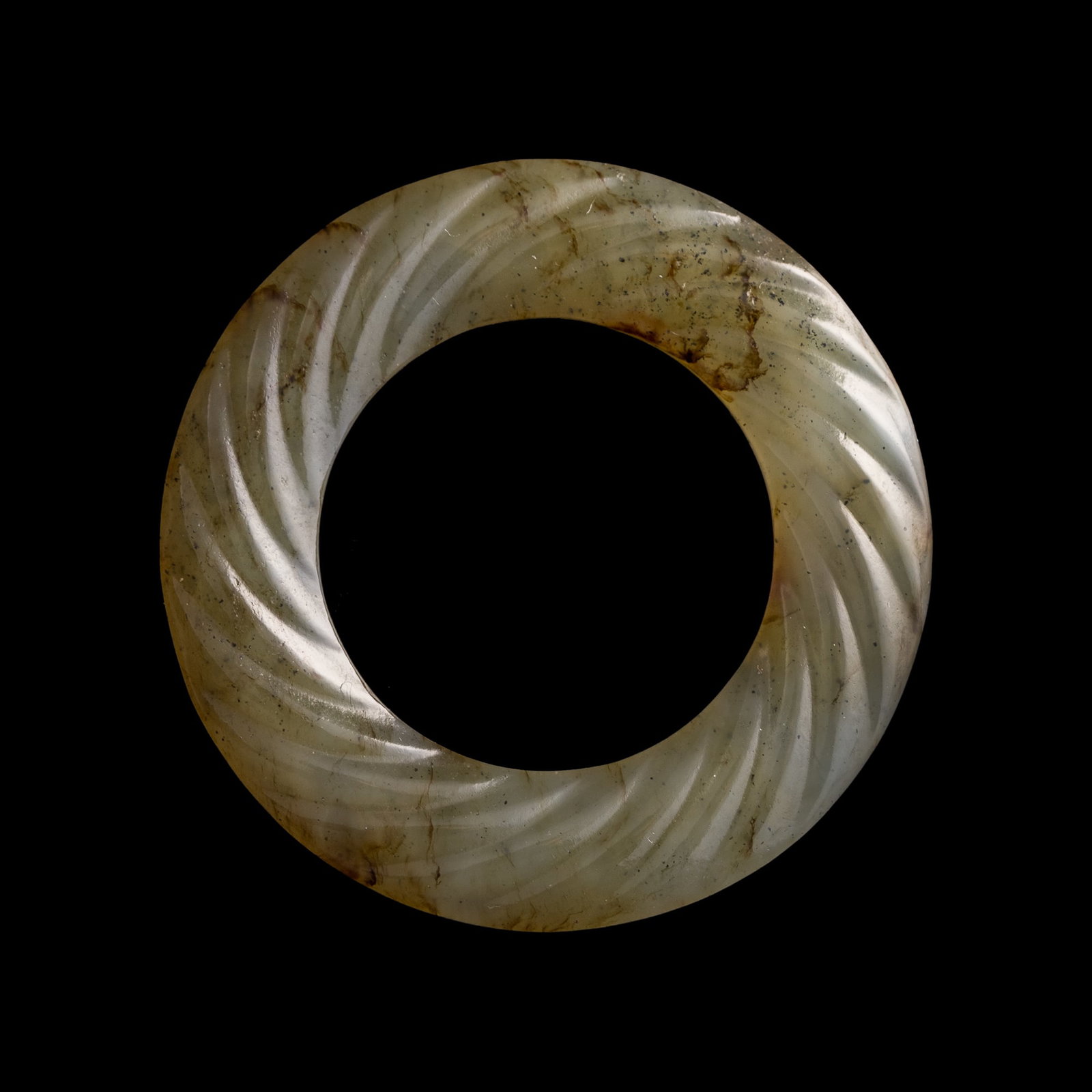 A Chinese twisted-rope jade ring, Ming dynasty or earlier: A Chinese twisted-rope jade ring Ming dynasty or earlier H: 1/8, Dia: 1 1/2 in. (H: 0.3, Dia: 3.8 cm.) Private collection, Minneapolis, Minnesota. Click here for h
