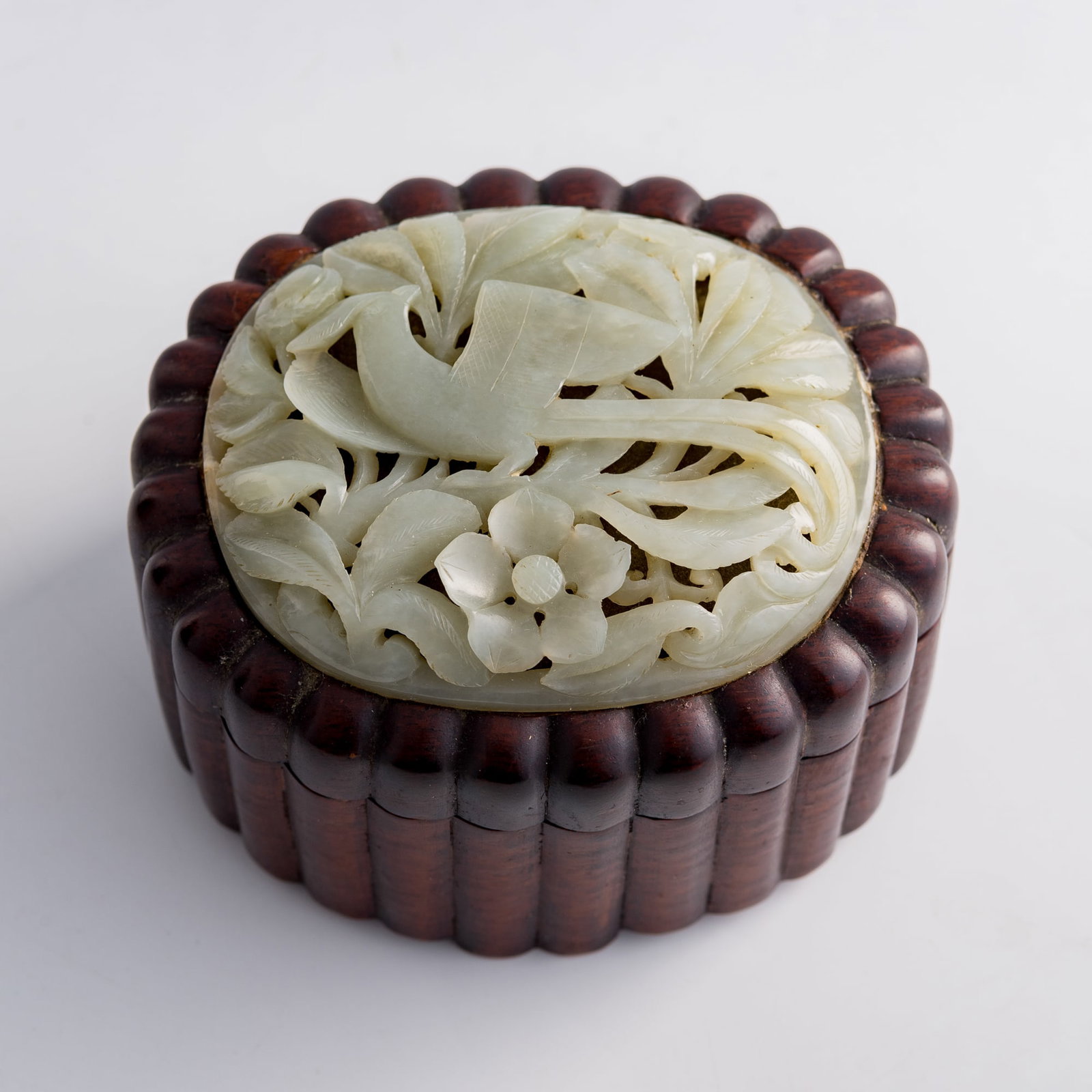 A Chinese hardwood box mounted with a Ming dynasty jade plaque: A Chinese hardwood box mounted with a Ming dynasty jade plaque Box: H: 3 1/2, W: 5, D: 4 in. (H: 8.9, W: 12.7, D: 10.2 cm.) Jade: H: 3 1/8, W: 3 7/8, D: 5/8 in. (H: 7.9, W: 9.8, D: 1.6 cm. (approx.)) 