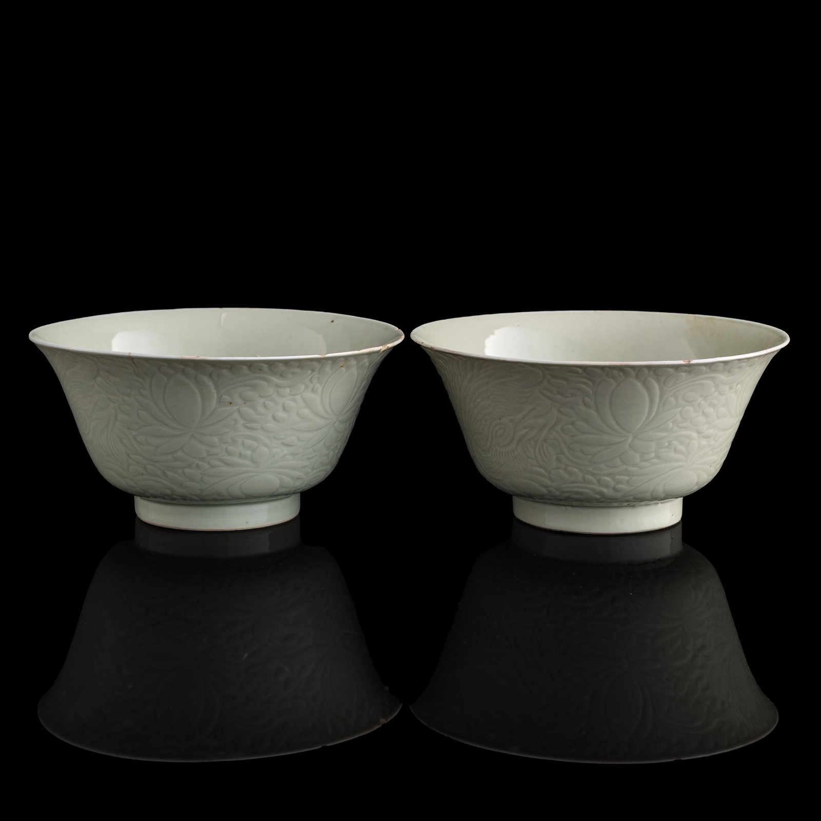 A pair of Chinese incised celadon bowls, Kangxi period, Qing dynasty: A pair of Chinese incised celadon bowls Kangxi period, Qing dynasty Each with two-character mark to underside, one with a Weschler's auction house sticker to underside. (2). H: 3, Dia: 6 1/4 in. (H: 7