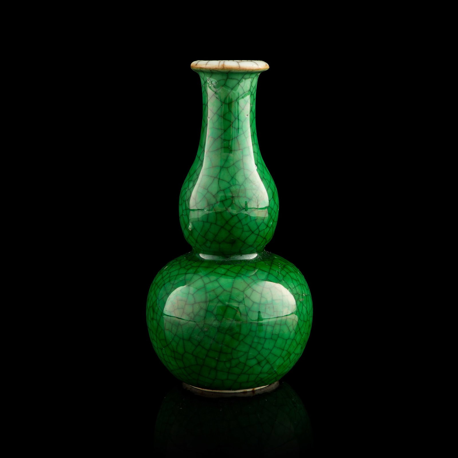 A Chinese green ge-type-glazed double-gourd vase, 19th century: A Chinese green ge-type-glazed double-gourd vase 19th century H: 4 7/8, Dia: 2 1/2 in. (H: 12.4, Dia: 6.4 cm.) From Mr. Yip of Seattle, Washington. Click here for