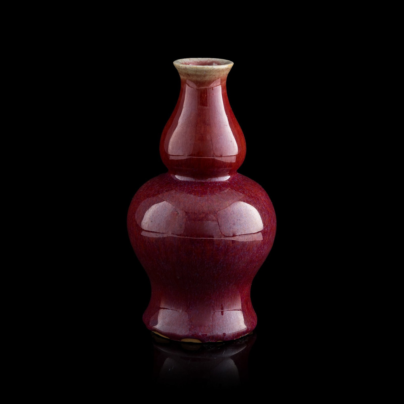 A Chinese flambe double-gourd vase, early 19th century: A Chinese flambe double-gourd vase early 19th century H: 8 3/4. Dia: 4 1/2 in. (H: 22.2, Dia: 11.4 cm.) Private collection, Pittsburgh, Pennsylvania. Click here fo