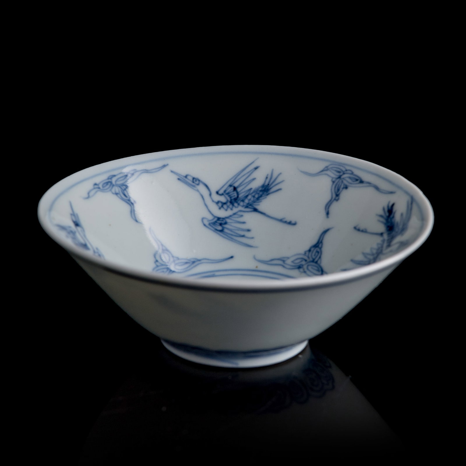 A small Chinese blue and white 'cloud and crane' bowl, Yongzheng period, Qing dynasty: A small Chinese blue and white 'cloud and crane' bowl Yongzheng period, Qing dynasty With six-character Yongzheng mark to underside. Sold with associated box. H: 1 3/8, Dia: 3 7/8 in. (H: 3.5, Dia: 9.