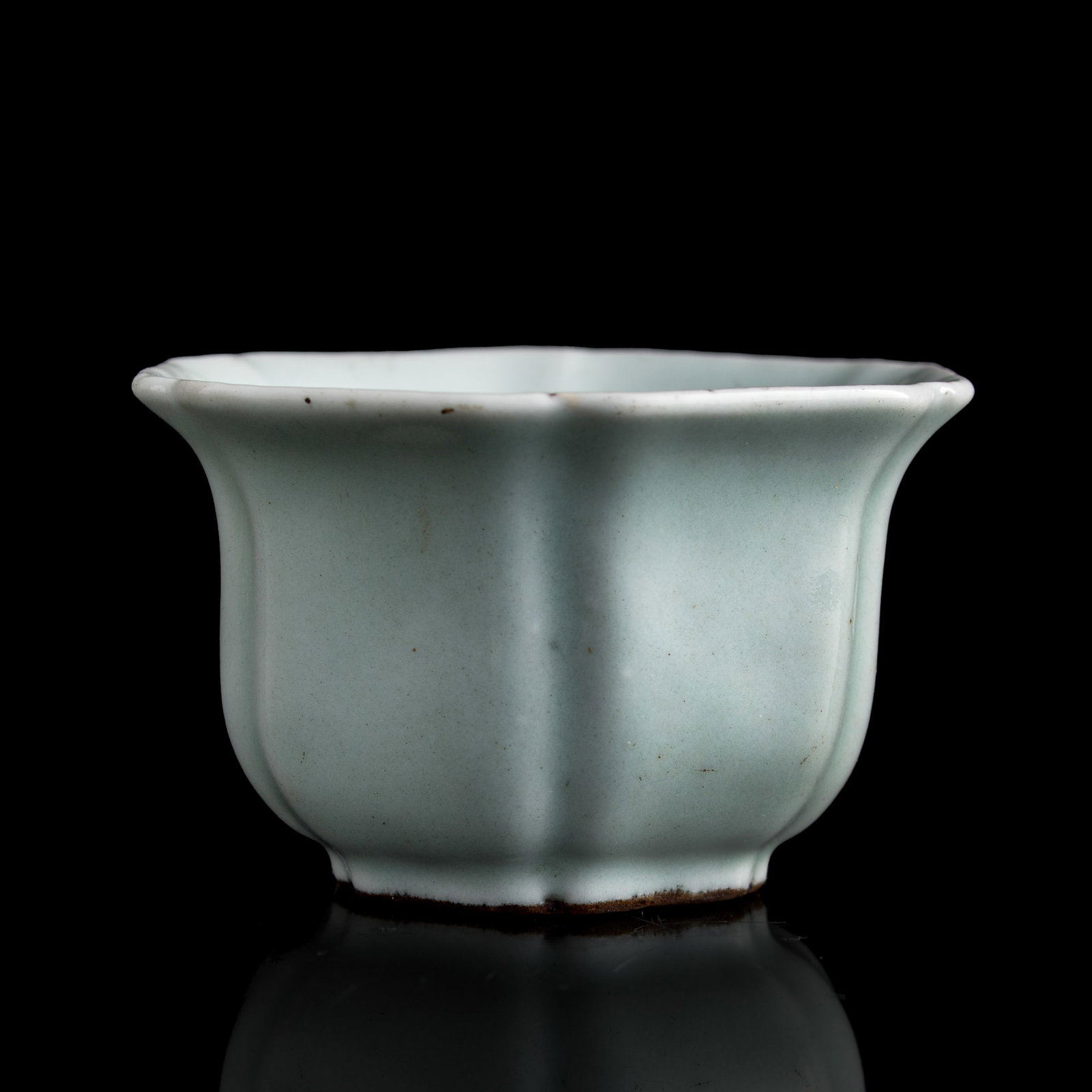 A Chinese celadon foliate-rim cup, Qianlong period, Qing dynasty: A Chinese celadon foliate-rim cup Qianlong period, Qing dynasty With six-character Qianlong mark to underside. H: 2 1/4, Dia: 3 7/8 in. (H: 5.7, Dia: 9.8 cm.) Private collection, Laurel, Maryland.