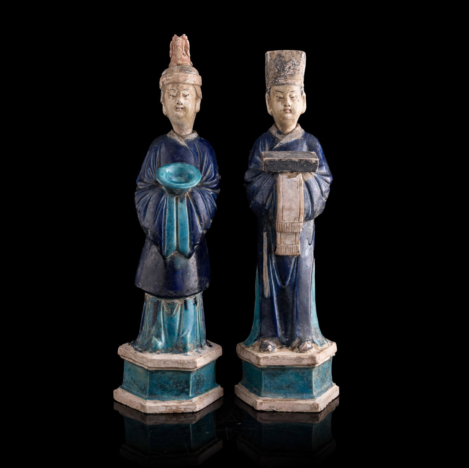 Two Chinese sancai pottery figures, Ming dynasty: Two Chinese sancai pottery figures Ming dynasty Includes a female official attendant wearing an elaborate headdress with a phoenix ornament and a male official attendant wearing an official's hat. H: 