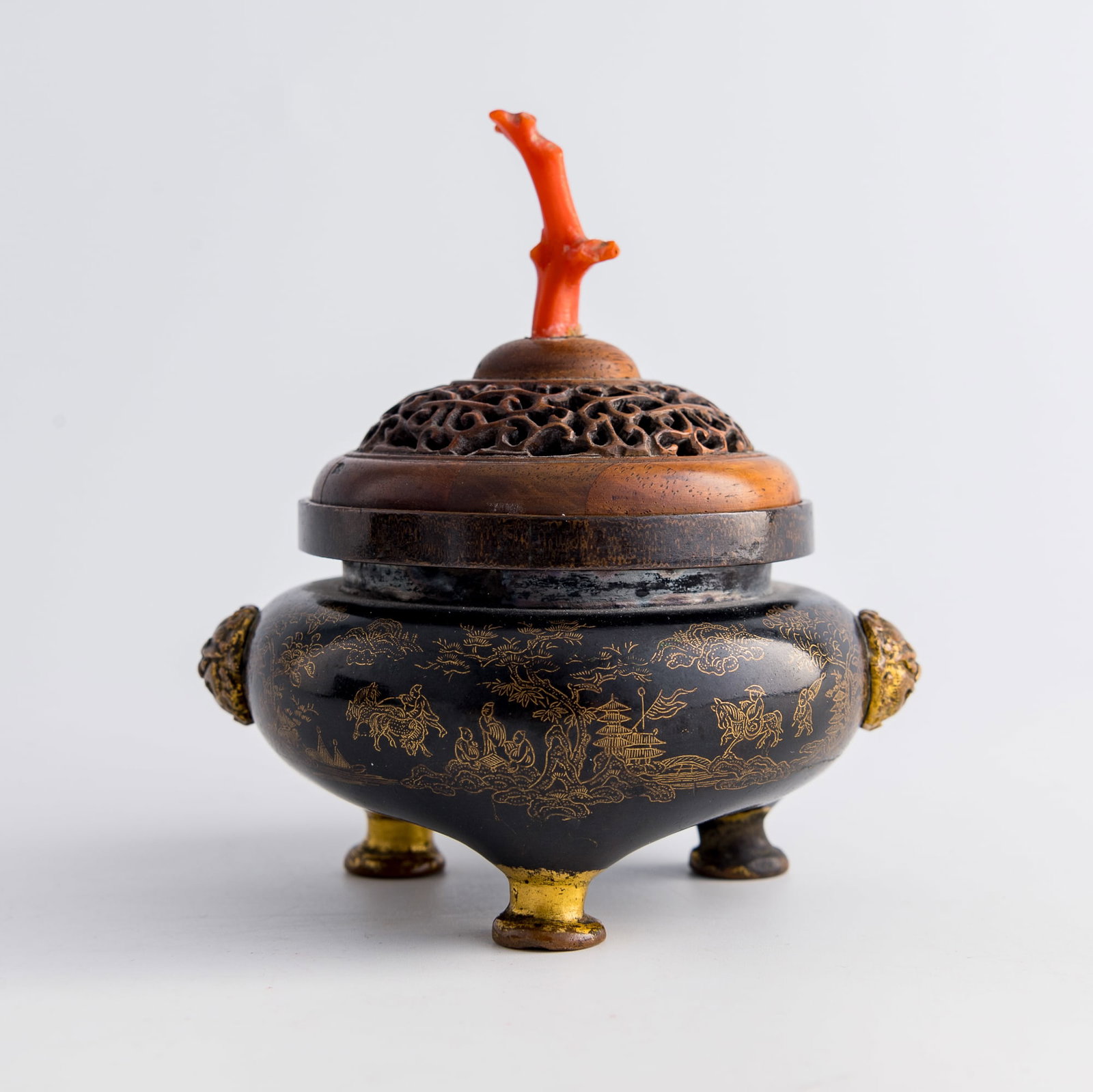 A Chinese gold-inlaid darkened copper tripod incense burner, Qianlong period, Qing dynasty: A Chinese gold-inlaid darkened copper tripod incense burner Qianlong period, Qing dynasty Decorated with a continuous landscape scene depicting auspicious beasts, horses, figures, and scattered pavili