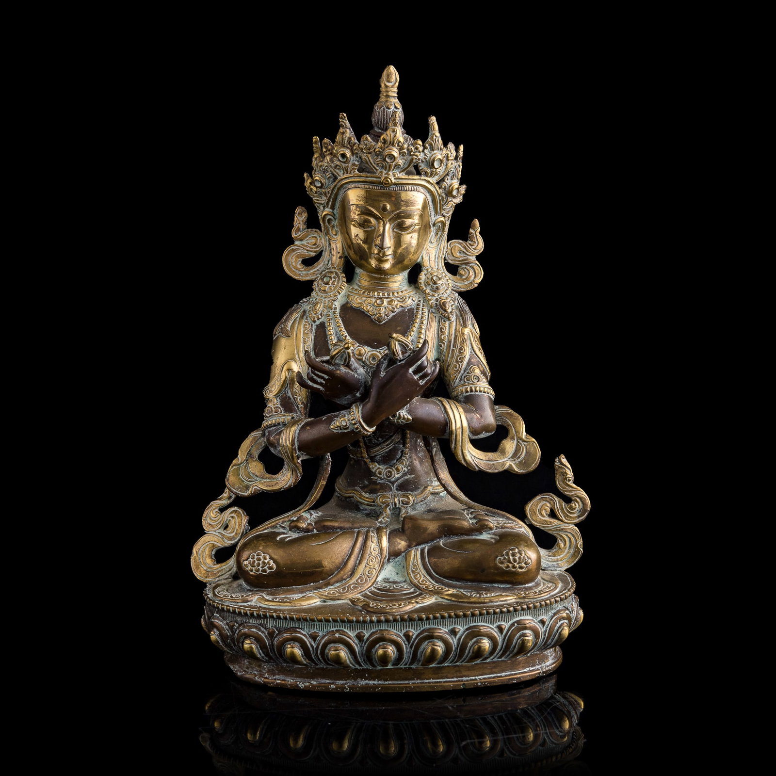 A Chinese gilt-bronze Vajradhara figure, 18th century: A Chinese gilt-bronze Vajradhara figure 18th century Vajradhara appears in the full lotus posture with crossed arms, representing the perfect union of compassion and wisdom H: 11 3/4, W: 7 1/2, D: 5 1