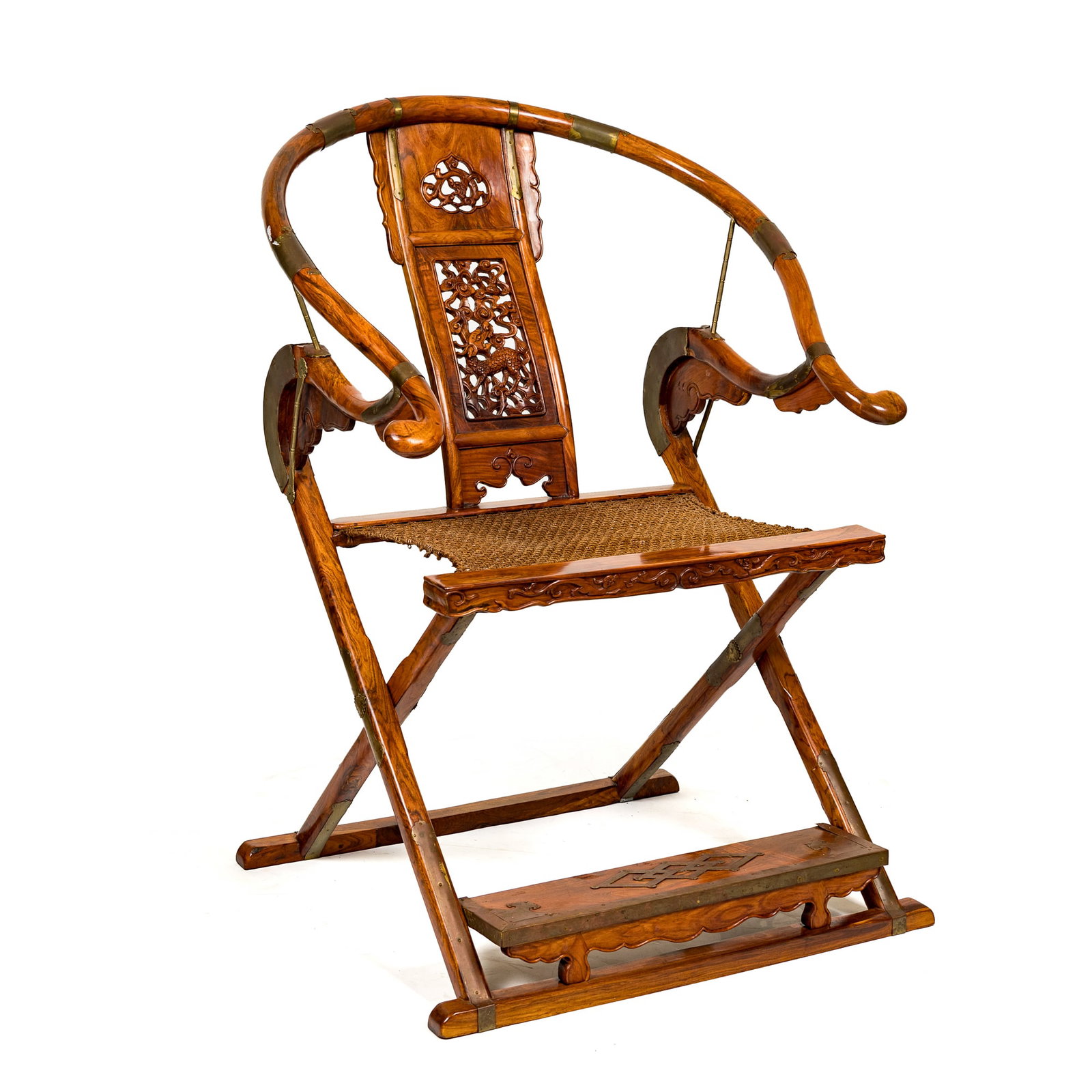 A Chinese huanghuali folding armchair: A Chinese huanghuali folding armchair Features pierced back design depicting a qilin amidst clouds and scrolling foliage. Folding armchairs like this one were used by government officials in imperial 