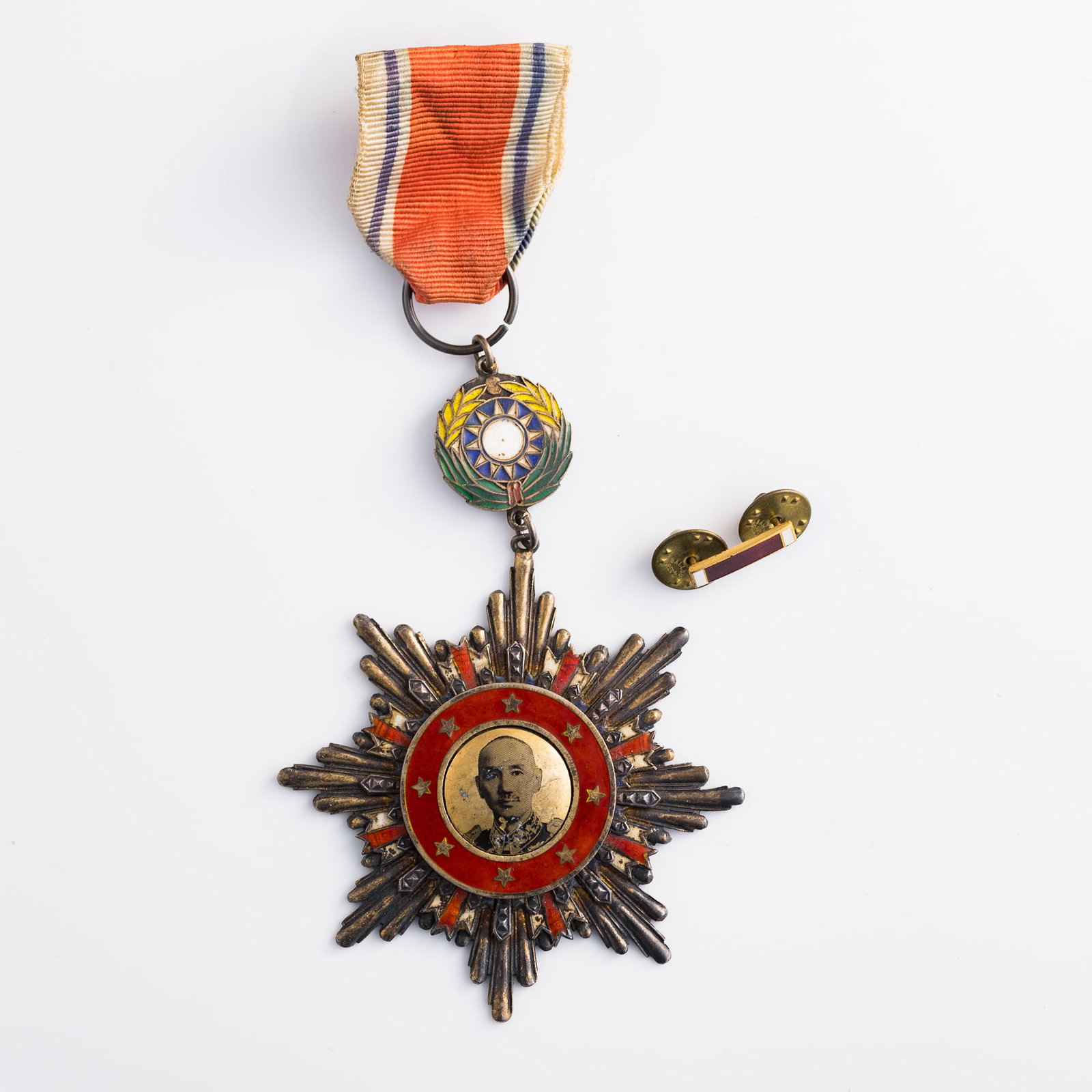 A Chinese victory medal of resistance against aggression, with ribbon and ribbon bar, 1945: A Chinese victory medal of resistance against aggression, with ribbon and ribbon bar 1945 Medal: H: 2 7/8, W: 2 3/4, D: 1/8 in. (H: 7.3, W: 7, D: 0.3 cm.) Overall height: 5 5/8 in. (14.3 cm.) Weight: 
