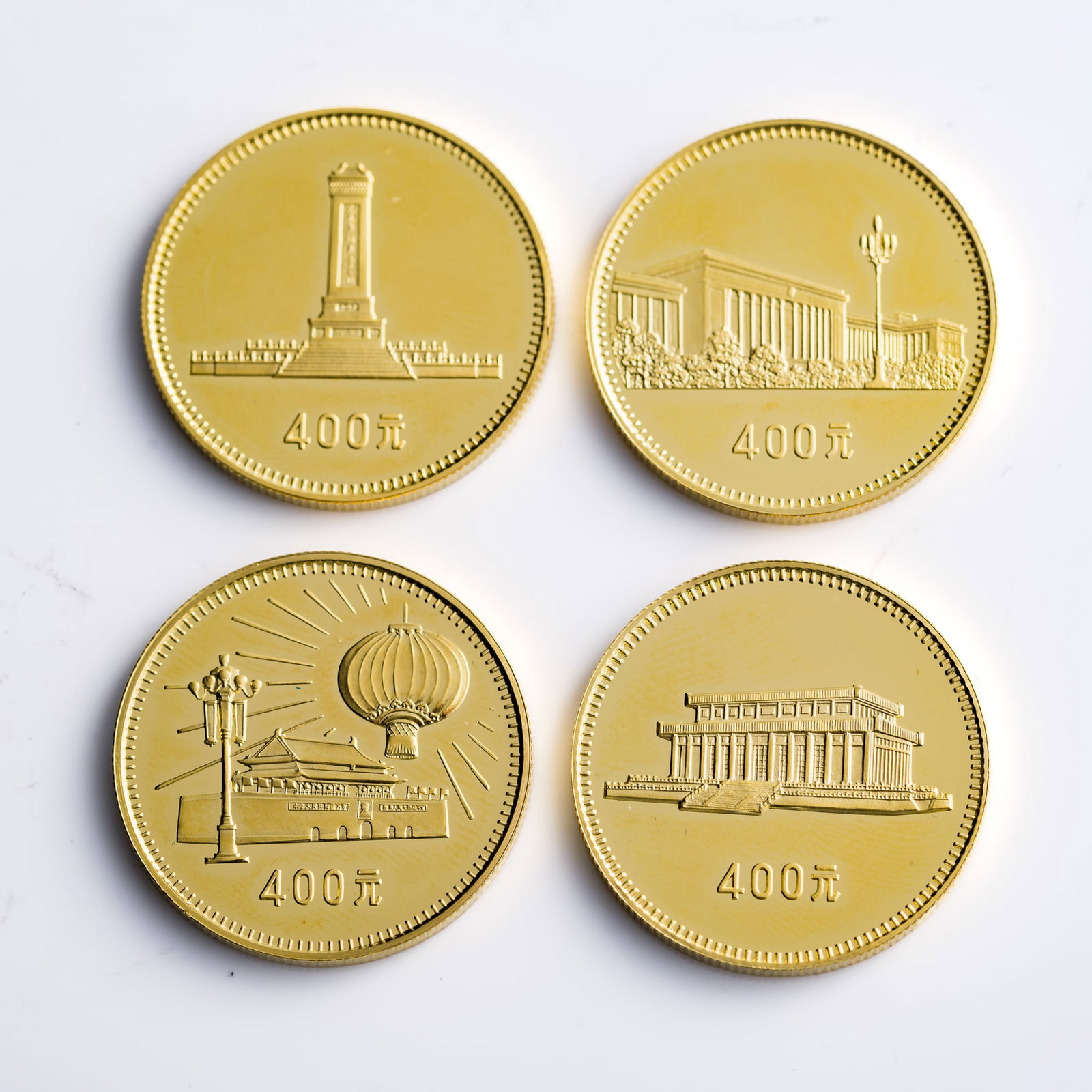 A Complete Set of four 1979 PRC 30th Anniversary Gold Commemorative Coins, 1979: A Complete Set of four 1979 PRC 30th Anniversary Gold Commemorative Coins 1979 Comes with original box and certificate of authenticity; numbered 10903. Diameter: 26.9 mm each, Depth range: 2.1-2.2