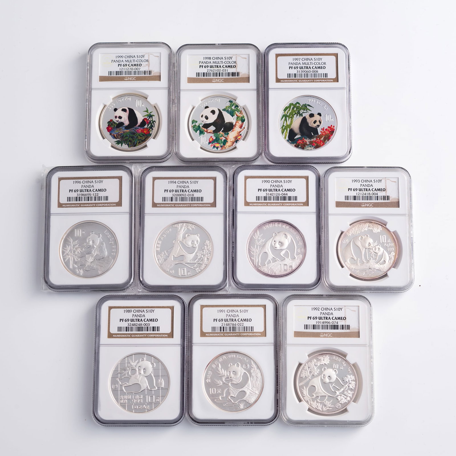 Ten graded Chinese silver panda coins, 1989-1999: Ten graded Chinese silver panda coins 1989-1999 One for each year from 1989 to 1999, with the exception of 1995. 1997, 1998, and 1999 coins are multi-color variant. Each coin graded by Numismatic