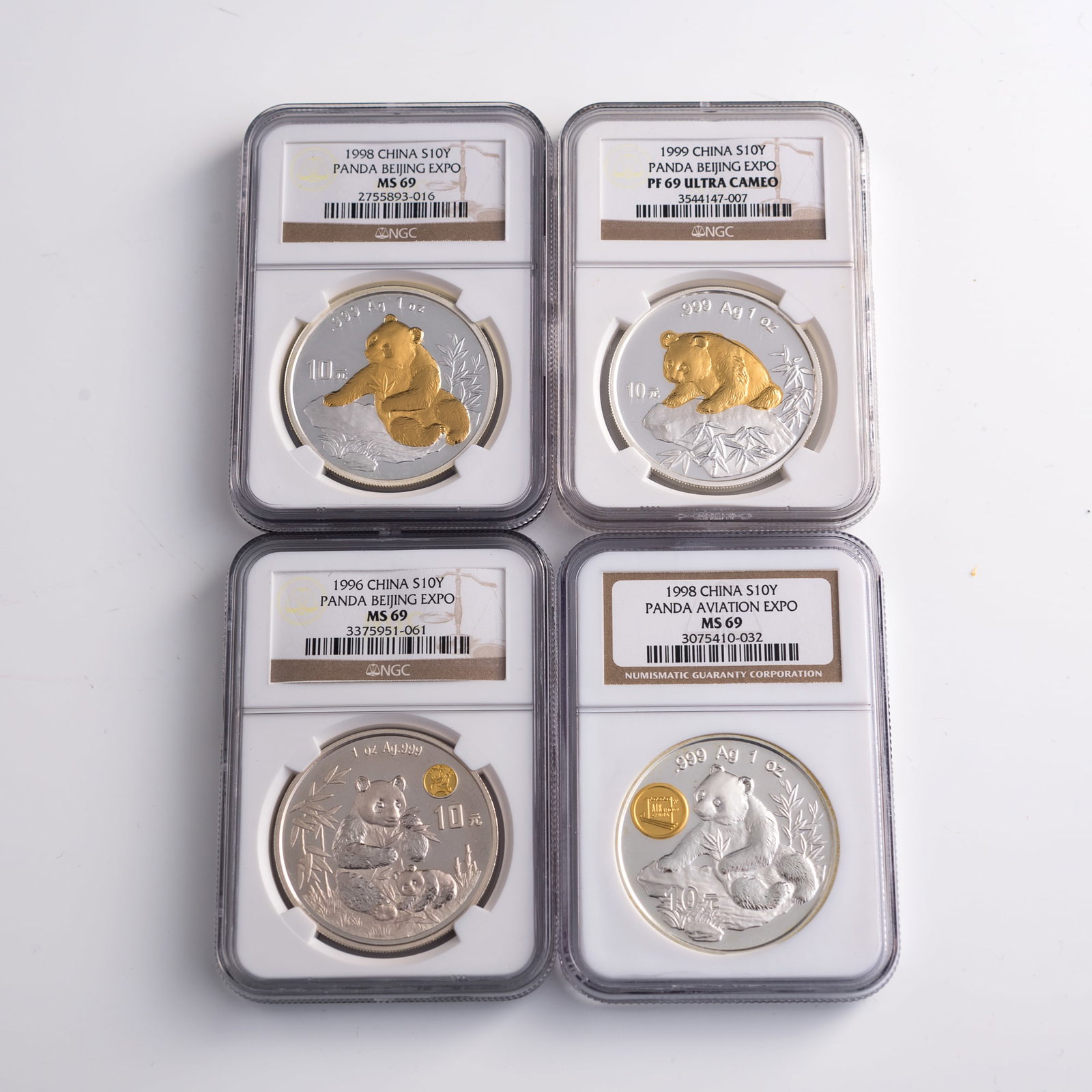 Four graded Chinese silver panda coins, 1996-1999 (1 of 6)