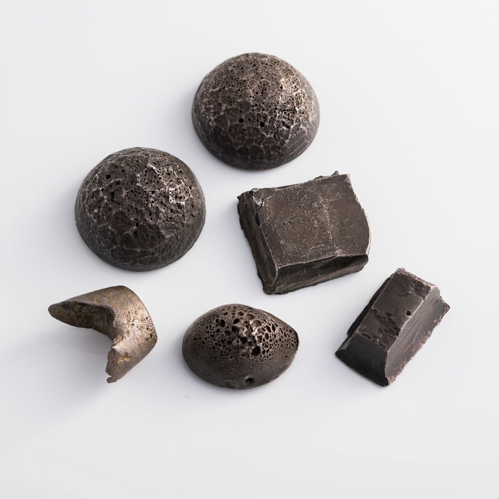Six Chinese silver ingots and cast pieces: Six Chinese silver ingots and cast pieces Dimensions varies. Largest: H: 24.2, W: 40.2, D: 39.1 mm Weight varies. Heaviest: 179.6 g From Ms. Walton, New Jersey. Her great-grandfather was a medical