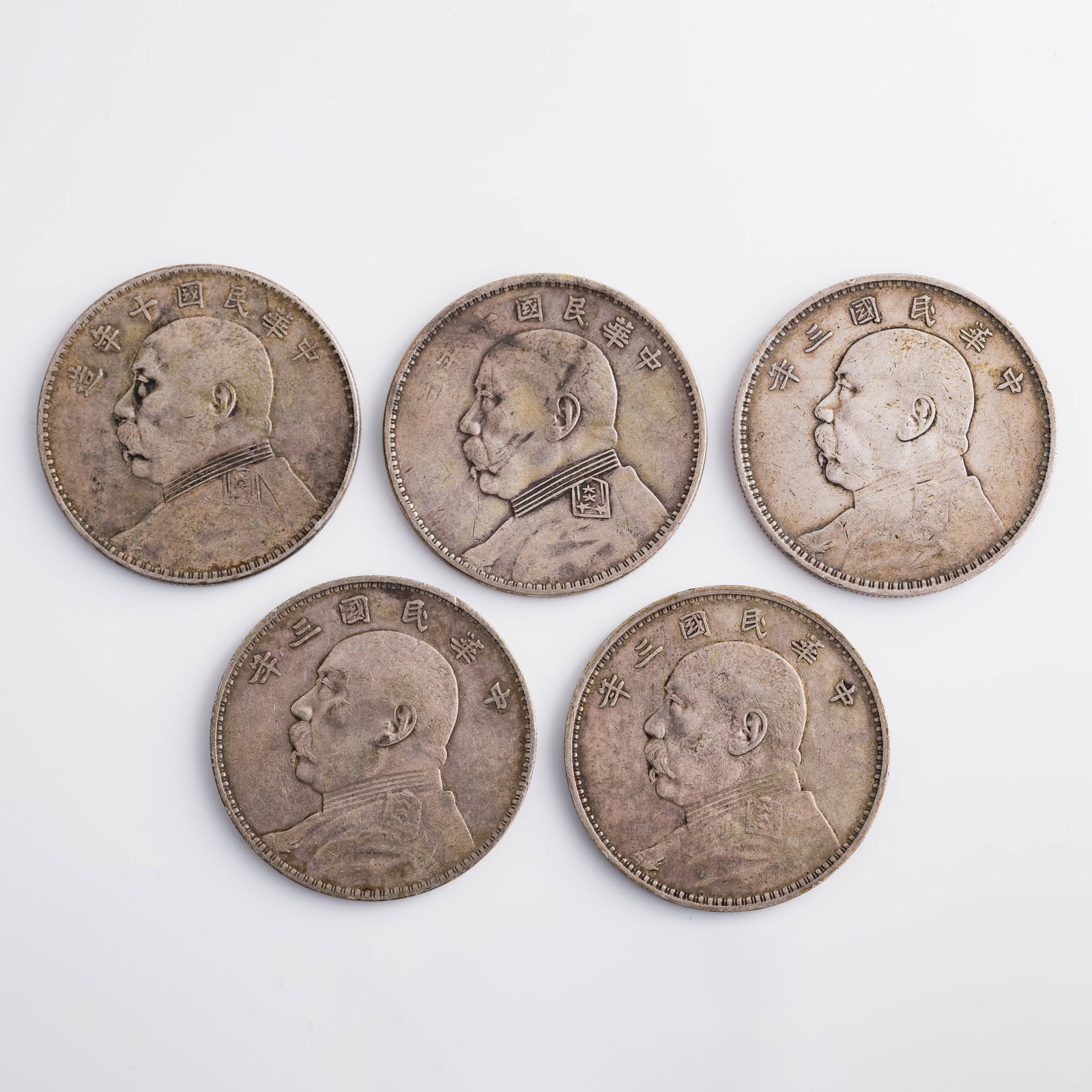 Five Chinese 'Yuan Shikai' silver dollars, 1914 and 1921: Five Chinese 'Yuan Shikai' silver dollars 1914 and 1921 Diameter range: 38.6-38.8; depth range: 2.2-2.4 mm. Weight range: 26.6-26.95 g Private collector, Calgary, Canada.