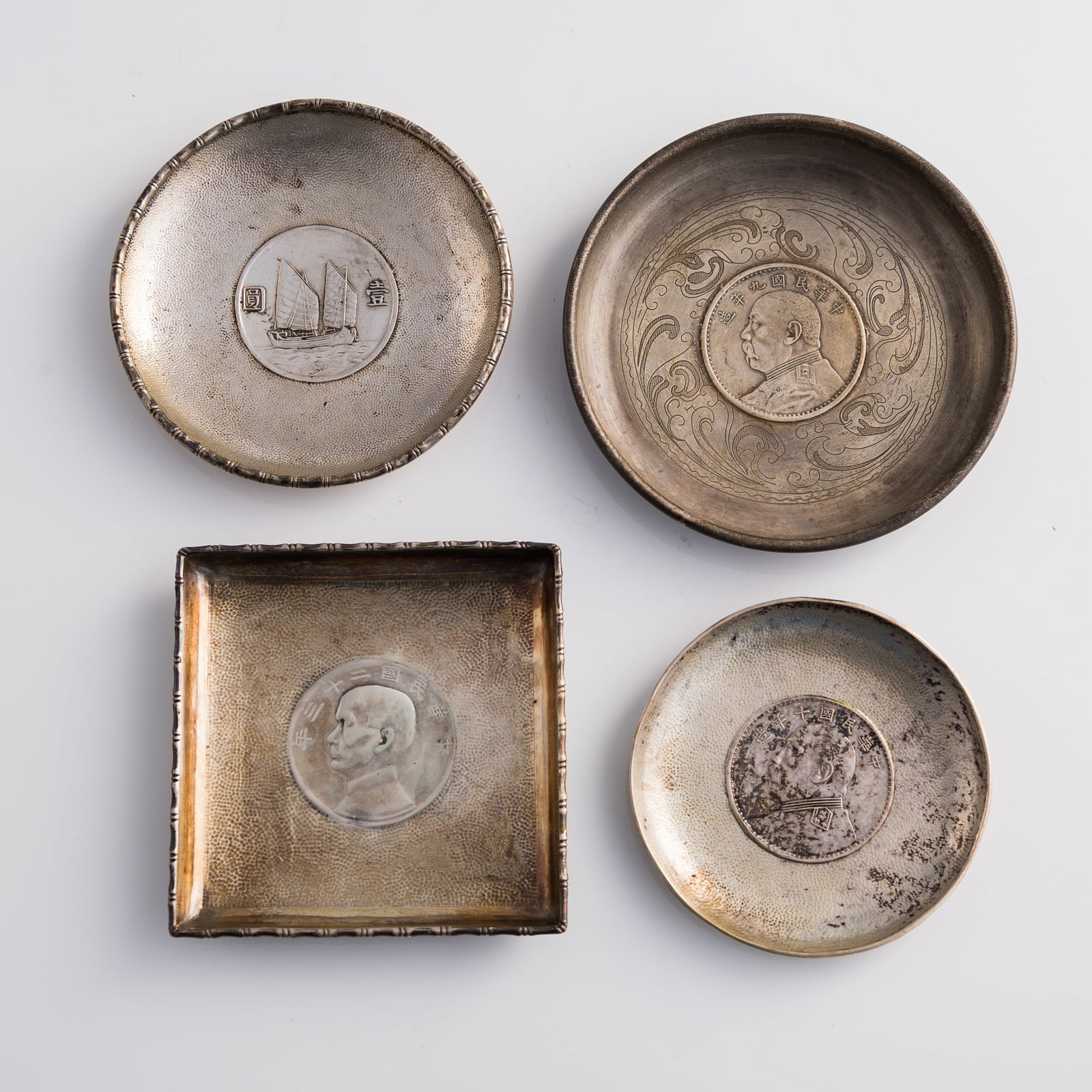 Four silver dishes inset with Chinese silver coins (1 of 11)