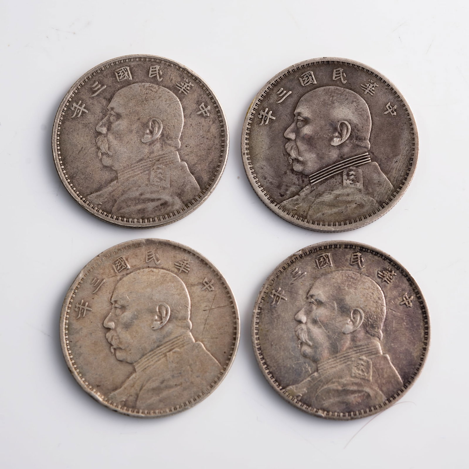Four Chinese 'Yuan Shikai' portrait silver dollars, 1914: Four Chinese 'Yuan Shikai' portrait silver dollars 1914 Diameter range: 38.7-39 mm; Depth range: 2.2-2.5 mm Weight range: 26.61-26.78 g From Mr. Shang of Wake Forrest, North Carolina; inherited from h