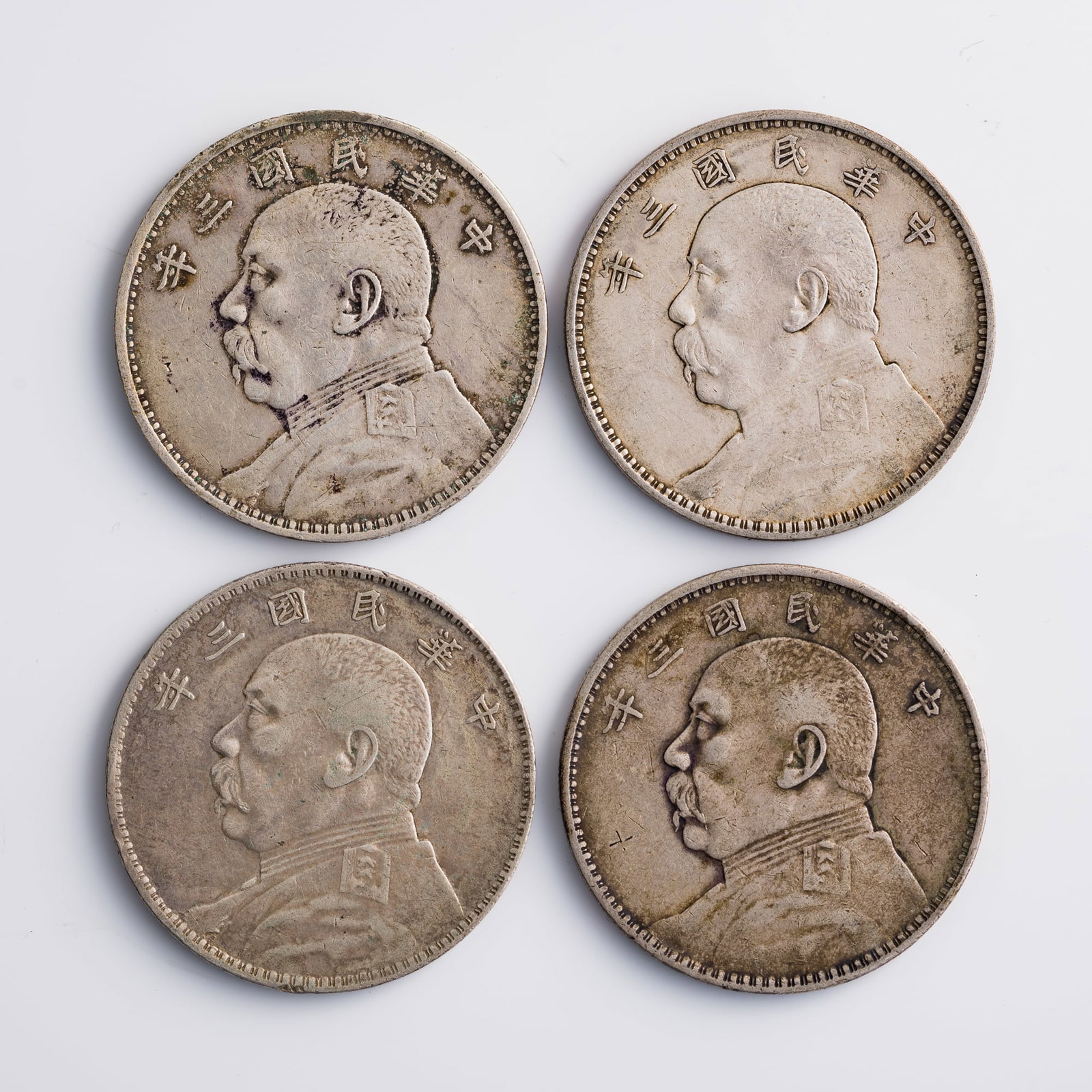 Four Chinese 'Yuan Shikai' portrait silver dollars, 1914: Four Chinese 'Yuan Shikai' portrait silver dollars 1914 Diameter range: 38.7-38.8 mm, depth range: 2.2-2.3 mm. Weight range: 26.66-26.78 g From Mr. Shang of Wake Forrest, North Carolina; inherited fro