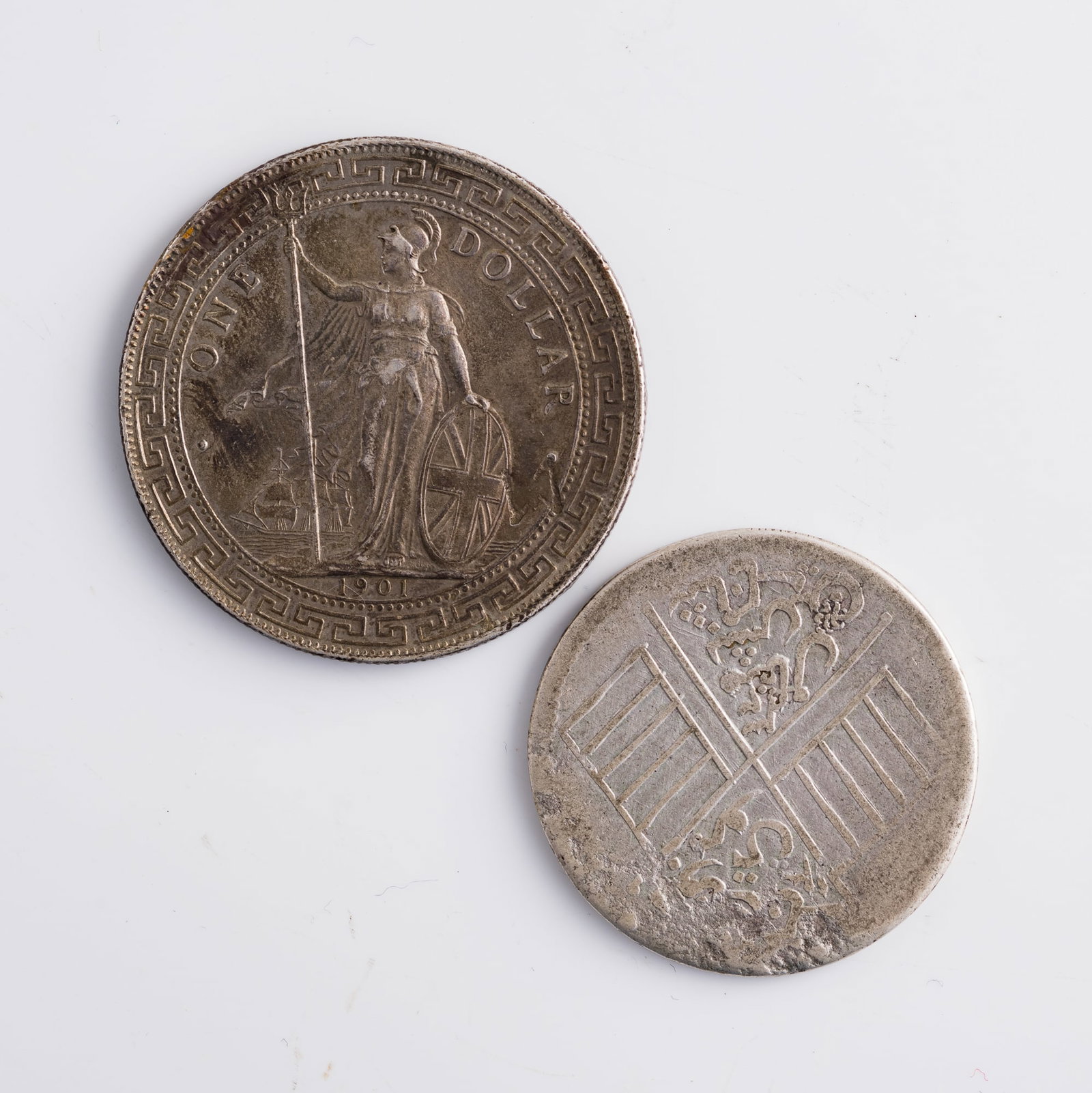 A Xinjiang Kashgar-minted 5 mace coin and a 1901 British trade dollar coin, late Qing and Republic: A Xinjiang Kashgar-minted 5 mace coin and a 1901 British trade dollar coin late Qing and Republic period Diameter: 39.2, depth: 2.4 mm. (trade dollar) Diameter: 33.2, depth: 2.1 mm. (5-mace coin) Weig
