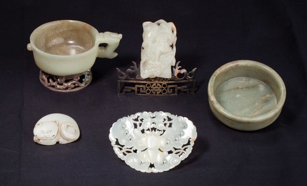 Five jade carvings 16th to 19th century: A group of five jade carvings from the 16th century to the 19th century the first item is a Ming dynasty celadon jade cup from the 16th century with a chilong shaped handle mounted on a silver base th