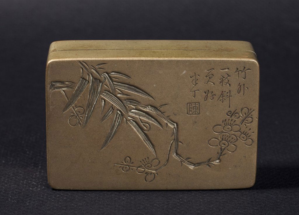 A 'Chen Banding' bronze ink box 20th century: A bronze ink box signed by 'Chen Banding' early 20th century finely incised with flowers and signed with 'Banding' and a seal 'Chen' approximately 3 3/4in long.
