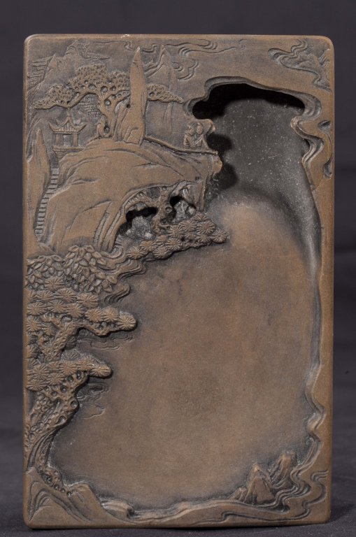 An 'chengni yan' inkstone 19th - 20th century: An inscribed 'chengni yan' inkstone marked Qianlong 19th to early 20th century skillfully carved with a landscape scene and marked as Qianlong period but is most likely from late 19th to early 20th ce