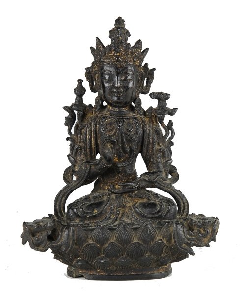 A bronze seated Guanyin Ming dynasty: A bronze seated Guanyin Ming dynasty cast bronze Guanyin sitting on a lotus pedestal approximately 8 1/4in high.