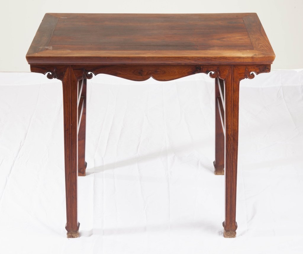A small Huanghuali altar table 18th century: A small Huanghuali altar table 18th century the rectangular top sits above a double curved apron and four square-cut legs (old restorations) approximately 30 1/2in high by 35 1/4in long and 21 1/2in w