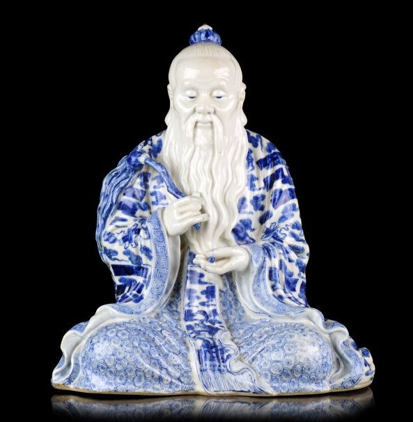 A 'Zeng Longsheng' statue 20th century: A blue and white porcelain statue of Daoist divinity stamped with 'Zeng Longsheng' early 20th century there is a Taoist whip in his hand stamped with 'Zeng Longsheng' at the bottom. Zeng Longsheng (19