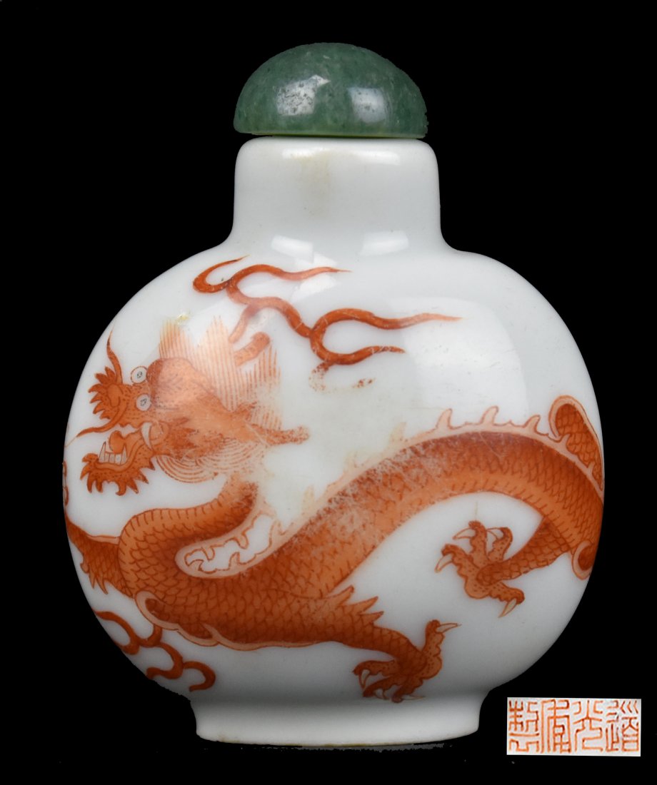 Porcelain Snuff Bottle, Daoguang Period: A Chinese Porcelain Snuff Bottle with Daoguang Mark and of the Period (1821-1850) A White porcelain snuff bottle with iron red dragon and flames, of rounded circular form, raised on a flared foot. It 
