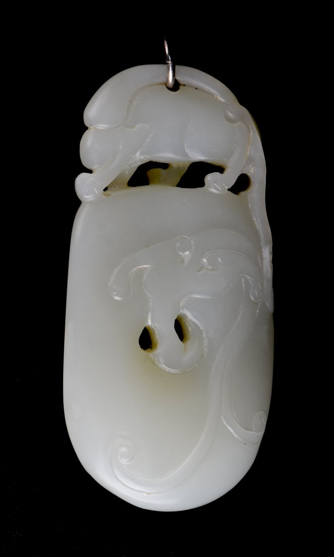 White Jade Toggle Pendant, 19th Century: A Carved Chinese White Jade Toggle Pendant, 19th Century This carved and pierced white jade toggle depicts a large squirrel on top visible from both sides. The body of the toggle is carved in bas reli