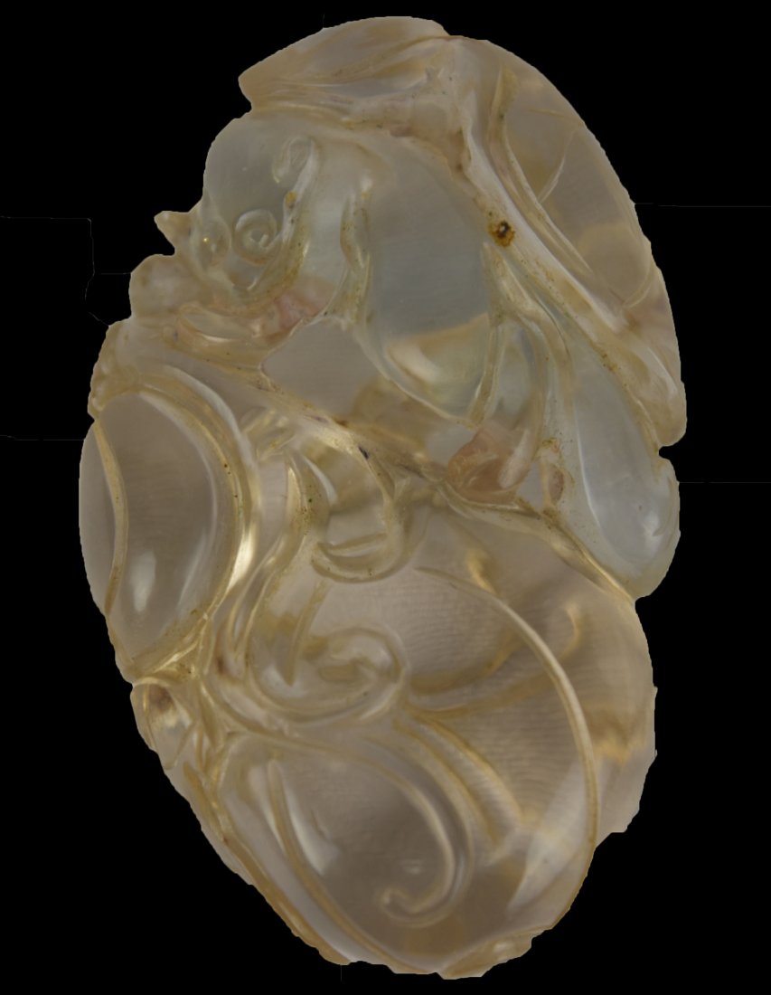 A Crystal Squirrel and Fruit Toggle, 19th Century: A Chinese Crystal Squirrel and Fruit Toggle, 19th CenturyThis crystal toggle is carved and pierced in the shape of a squirrel and fruit. It is approximately 1 3/4 in long X 1 1/8 in wide.From a Boston