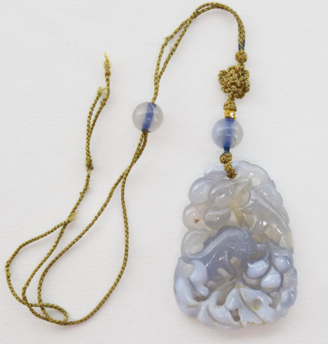 Agate Squirrel and Grapes Toggle, 19th Century: A Chinese Agate Squirrel and Grapes Toggle, 19th Century This carved and pierced agate openwork toggle depicts a squirrel and grapes, with a knotted string upon which are strung two 9.5mm agate beads.