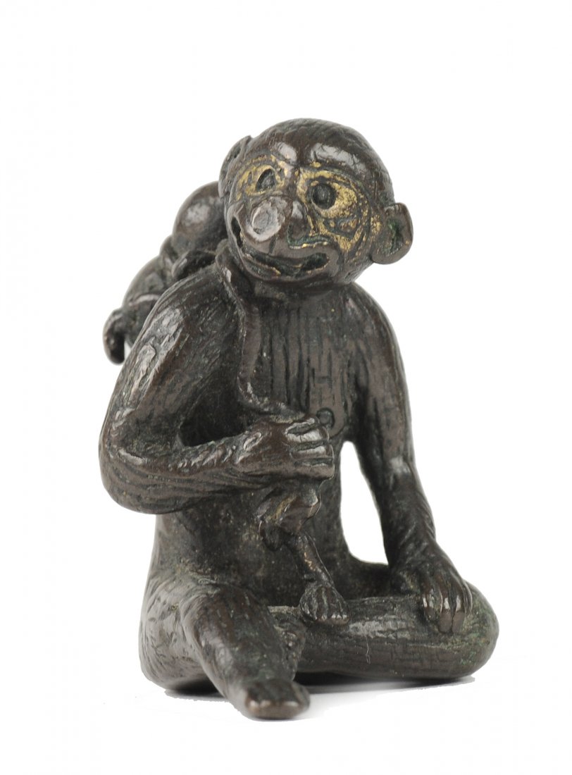 Bronze Monkey Carrying a Double Gourd Paper Weight: A Chinese Bronze Paper Weight of a Monkey Carrying a Double Gourd, Ming Dynasty (1368-1644) This bronze paper weight depicts a seated, smiling monkey that is carrying a double gourd on its back. It is