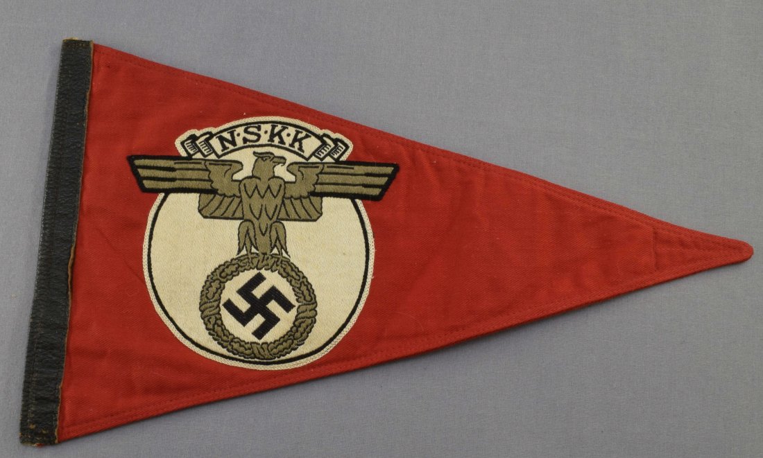 German WWII NSKK Motorcycle Korps Pennant: German World War II NSKK Motorcycle Korps Staff Car Pennant. Measures 13 7/8" wide by 8 1/8" tall. Has a machine embroidered NSKK eagle on both sides. Four piece machine sewn construction plus the lea