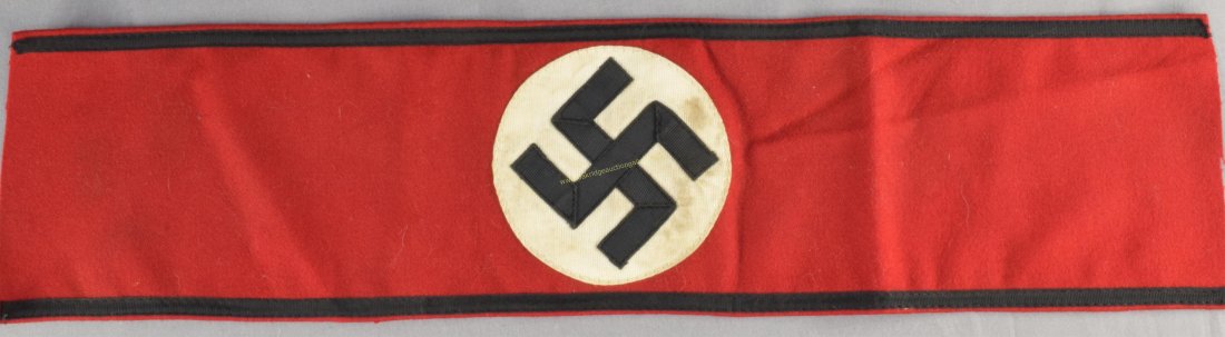 German WW2 Waffen SS Officers Overcoat Arm Band: German World War II Waffen SS Officers Overcoat Arm Band. Measures 19 1/4" wide by 4 5/8" tall. Has a multi piece swastika in the center sewn onto a white round circle. There is a black band sewn alon