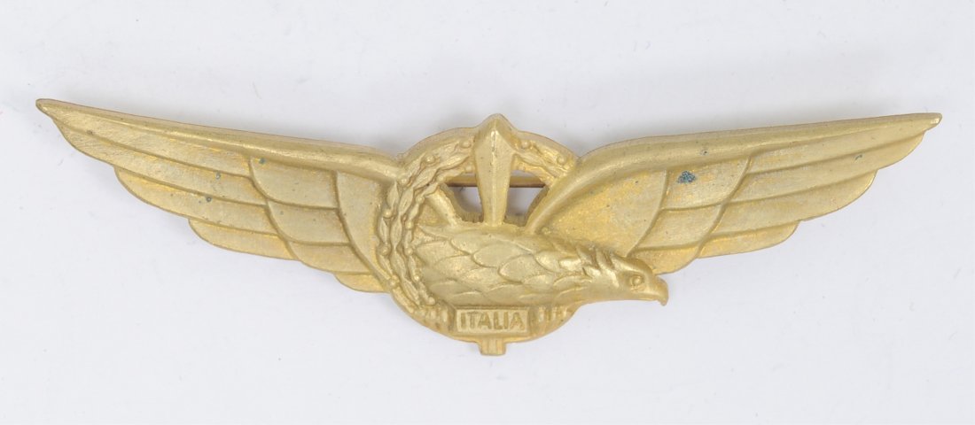 Italian German WWII Axis Pilot Wing: Italian German WWII Axis Pilot Wing. Measures 2 13/16" wide. The reverse side is maker marked 'Brevettato'. Has a thin horizontal pin back. Brass construction. Condition: Excellent condition. Note: So