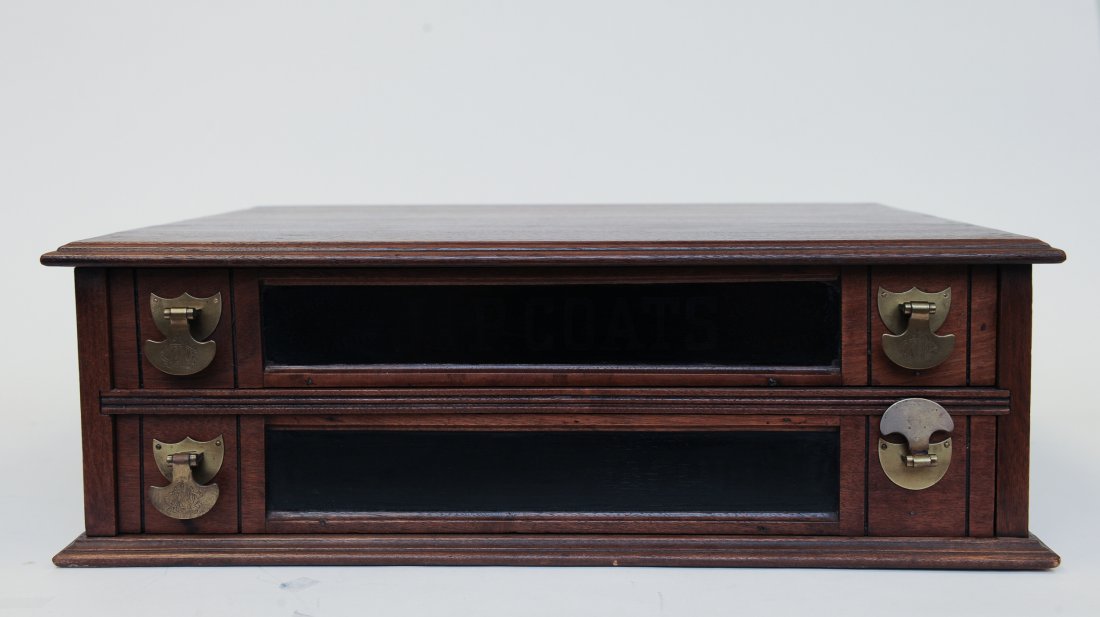 J. & P. Coats' Walnut 2-Drawer Spool Cabinet: Antique J. & P. Coats' Walnut 2-Drawer Spool Cabinet. This walnut cabinet has dovetail construction and four brass pulls. It has the classic J. & P. Coat's logo on the top drawer. Provenance: From an 