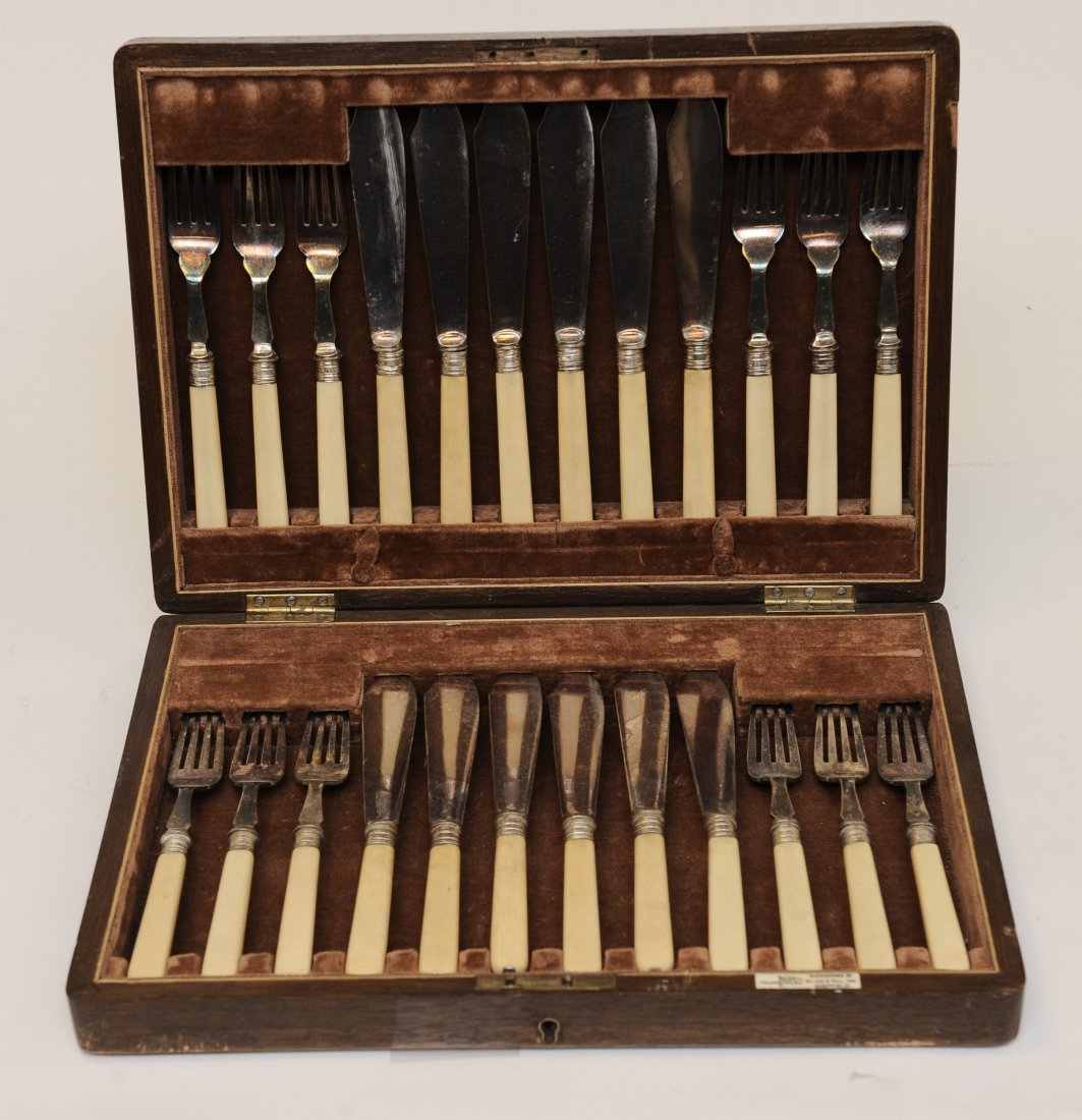 Fish Eating Set in a Case: A Vintage Walker & Hall 12 Piece Silver Plate & Celluloid Handled Fish Fork & Knife Set. The set has a Walker & Hall Hallmark. It is housed in a wooden box that is lined with molded velvet. The box ha