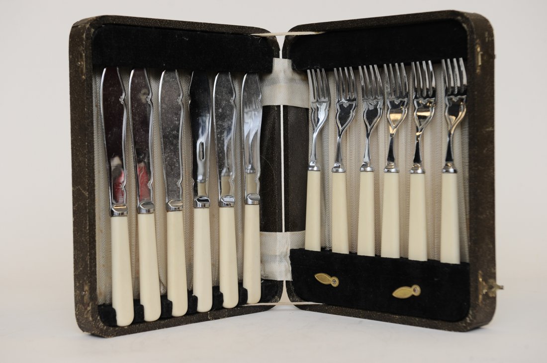 Vintage 12 Piece Chrome Plated Flatware: A Vintage 12 Piece Chrome Plated & Celluloid Handled Flatware. The knives and forks are in the original molded case that is velvet and fabric lined. The cutlery has a simple scroll design. It is stamp