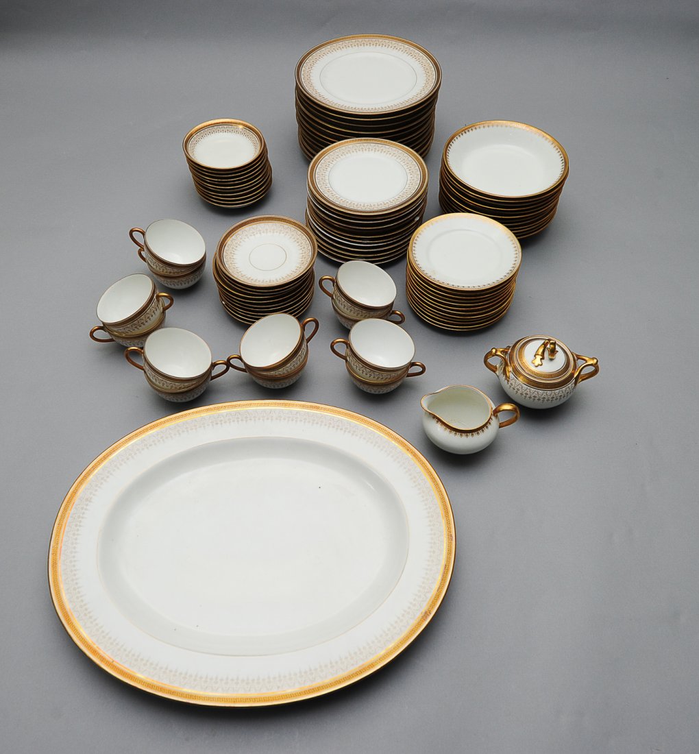 85 Piece Limoges Gilt Rimmed Dinnerware, C. 1910: 85 Pieces of Limoges Dinnerware. Lot includes: (1) 6" X 5" lidded sugar bowl, (1) 18" X 15" oval platter, (12) 7 1/2" salad plates, (12) 9 3/4" dinner plates, (11) 5" bowls, (12) 4 1/2" X 2 1/4" teacu