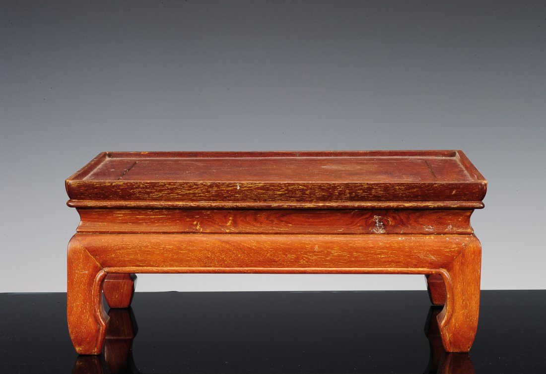 Simple Wooden Tea Table: This Asian-style tea table has simple aprons and four cuffed feet. The dimensions are 14 3/4" X10" X 6 1/2". All measurements are approximate. Condition: The wood is moderately worn and the table is s