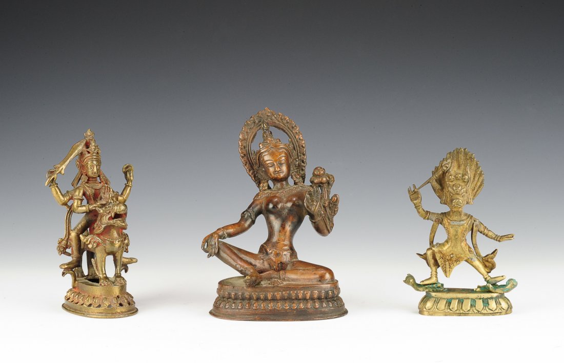 Three Statues of Deities: 1. Bronze statue of Arya Tara. The statue's hands are forming the vitarka mudra and she sits upon a lotus base. It is 4 1/2" X 4 3/4" X 6 1/2". 2. This brass statue depicts a boar like god, possibly t