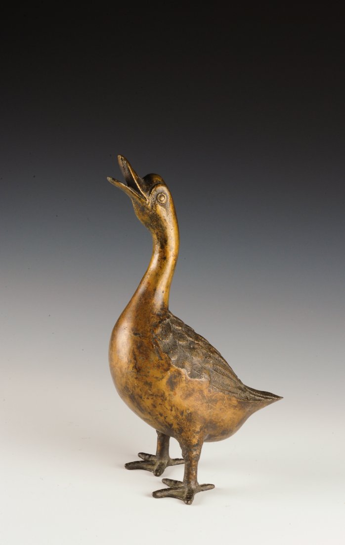 Bronze Goose Statue: This statue of a goose looking upwards with an open mouth was formerly used as a doorstop. The dimensions are 6" X 3 1/2" X 11 1/4". All measurements are approximate. Condition: It is in overall good 